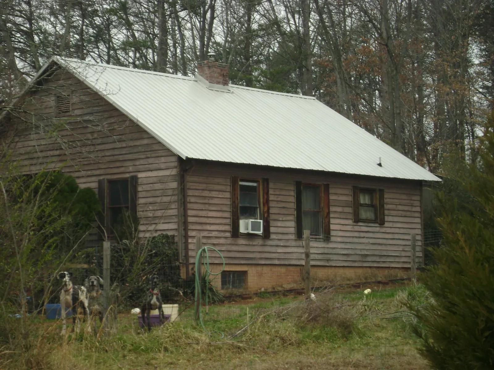 White metal roof on an old wood sided farmhouse, from a Metal Roof Installation job in Almond